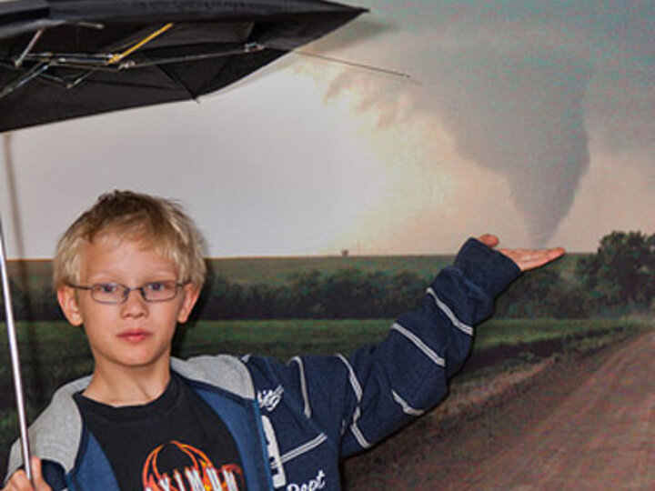 a perspective photo showing a kid holding a tornado